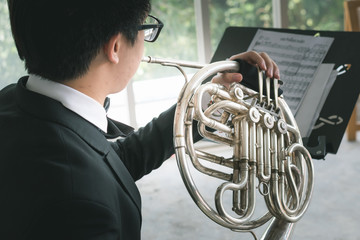 professional musical instrument concept : musician artist playing metal french horn - obrazy, fototapety, plakaty