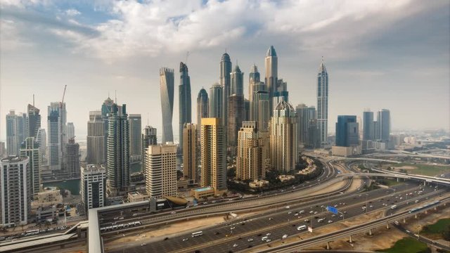 Fantastic skyline of Dubai Marina. Scenic elevated view over skyscrapers and highways at daytime. 4K time lapse. 
