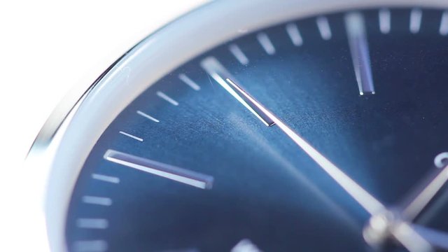 Time passing on blue hand clock face closeup