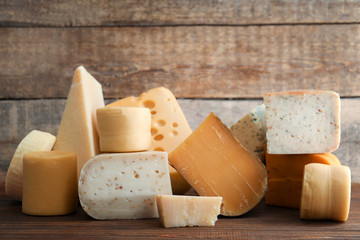 Different kinds of delicious cheese on table