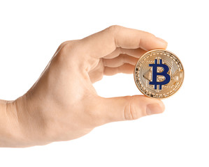 Hand holding golden bitcoin on white background