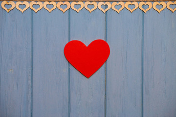 Red paper Heart of love with clips on blue wooden background. Romantic symbol. Love concept