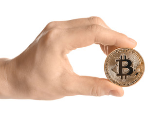 Hand holding golden bitcoin on white background