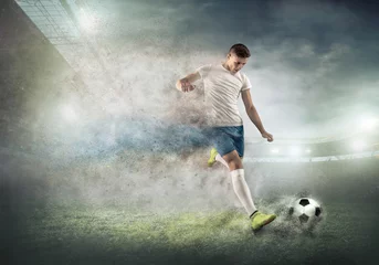 Foto op Canvas Soccer player on a football field in dynamic action at summer da © Andrii IURLOV
