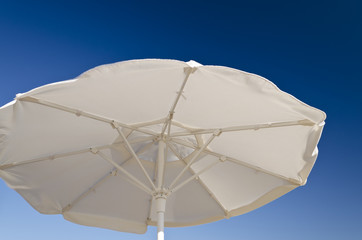 Beach umbrella against the blue clear sky on the beach