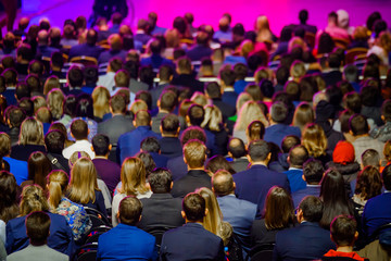 People attend business conference in the congress hall