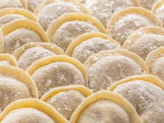 Traditional Russian handmade dumplings frozen on the board. Russian pelmeni. Ravioli