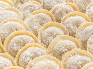 Traditional Russian handmade dumplings frozen on the board. Russian pelmeni. Ravioli