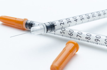 Fototapeta premium insulin syringes on white background, closeup
