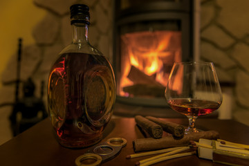 Time to enjoy! Quality cigars and cognac on a wooden table and other accessories such as cigar...