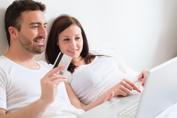 Happy couple searching for consumer advice in internet