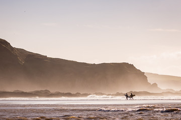Surfers leaving the ocean