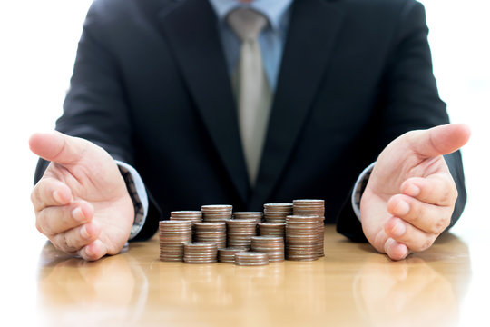 Businessman Protect Stack Of Coins