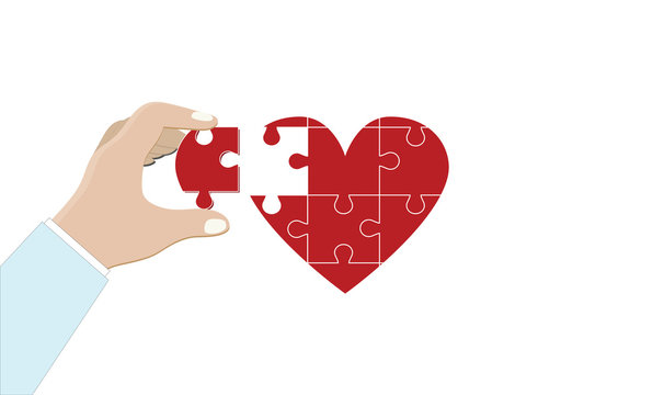 
A hand in a white coat (doctor) holds a piece of the puzzle from the missing figure in the shape of a heart. Health and medicine. 