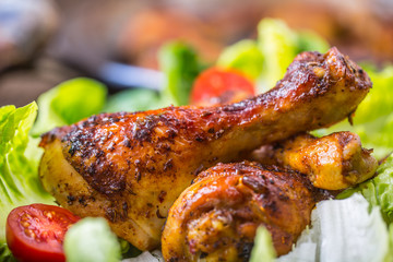 Grilled chicken legs lettuce and cherry tomatoes. Traditional cuisine. Mediterranean cuisine