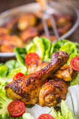 Grilled chicken legs lettuce and cherry tomatoes. Traditional cuisine. Mediterranean cuisine