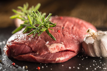 Beef steak. Raw Flank steak with rosemary garlic salt and pepper.