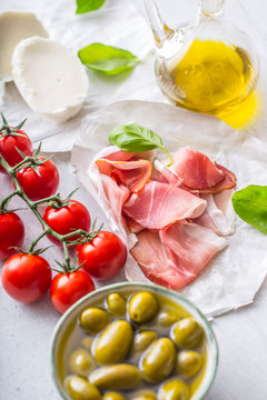Prosciutto Olives olive oil mozzarella cheese tomatoes basil -  ingredients italian or mediterranean cuisine