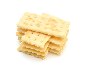 Stack of saltine crackers isolated on white. 