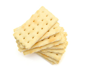 Stack of saltine crackers isolated on white. 