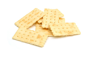 Stack of saltine crackers isolated on white. 