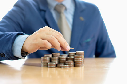 Close-up Of A Businessman Making Stack Of Coins