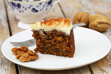 Slice of delicious carrot cake with walnuts
