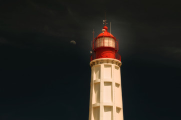 Lighthouse on the island of Culatra, Algarve, southern Portugal, moon. 