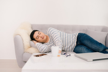 Young handsome asian man sleeping on sofa.