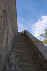 Fototapeta na wymiar Corsica, 01/09/2017: dettagli architettonici delle antiche mura della Cittadella arroccata di Calvi, famosa meta turistica sulla costa nord-occidentale dell'isola