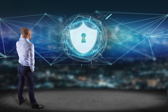 Businessman In Front Of A Wall With Security Protection Icon On A Futuristic Interface