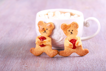 Bear cookies with cherry and cup of chocolate