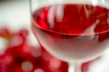 Close-up of red wine and the glass against grape