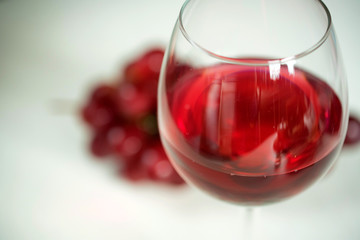 Close-up of red wine and the glass against grape