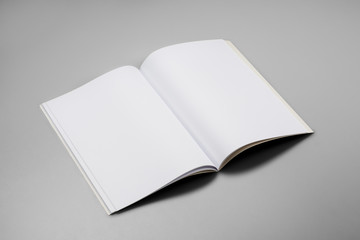 Mock-up magazine, book or catalog on gray table. Blank page or notepad on solid background. Blank...