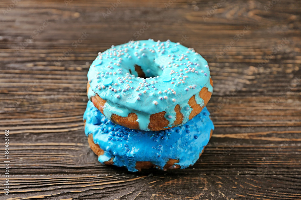 Wall mural tasty donuts on wooden table