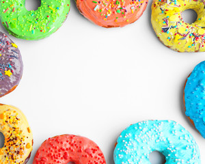 Tasty colorful donuts on white background