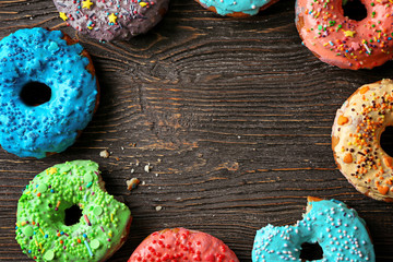 Tasty donuts on wooden table
