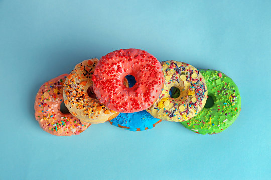 Tasty donuts on color background