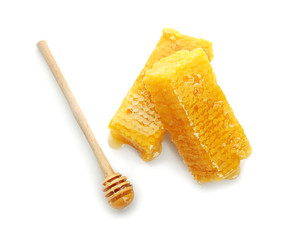 Fresh honeycombs with wooden dipper on white background