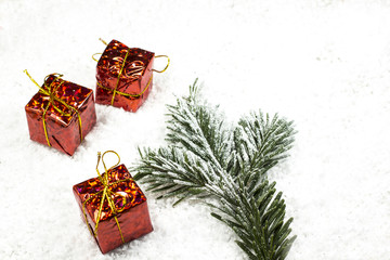 Christmas gifts in red packing on snow. Top view
