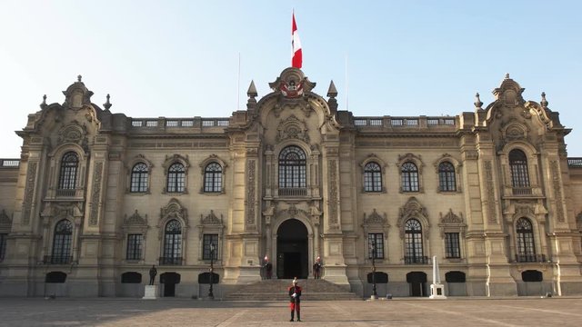 guard on duty and the front exterior of government palace in lima, peru