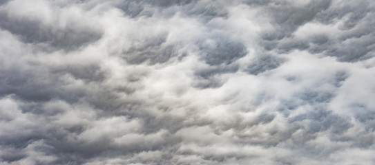 Obraz premium The panorama of overcast texture with clouds. Copy space.A lot of clouds in dramatic filter.