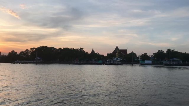Crossing the Chao Phraya River during sunset in Bangkok Thailand