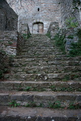 Stone staircases and rusty iron gate of an old castle