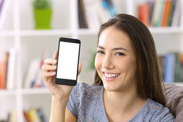 Lady showing blank smart phone screen at home