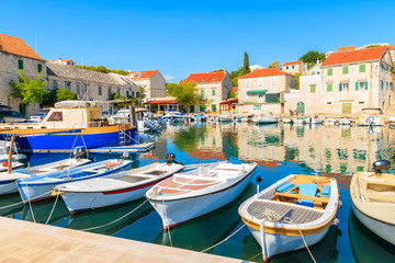Fototapeta na wymiar Row of fishing boats anchoring in Sumartin port on Brac island, Croatia
