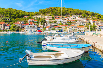 Fototapeta na wymiar Fishing and sailing boats in beautiful port of Pucisca, Brac island, Croatia