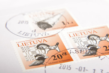 KAUNAS, LITHUANIA - September 18, 2017: Lithuanian post stamps with text "LIETUVA" ("LITHUANIA") and traditional objects: trumpet and clay whistles