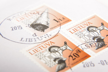 KAUNAS, LITHUANIA - September 18, 2017: Lithuanian post stamps with text "LIETUVA" ("LITHUANIA") and traditional objects: trumpet and clay whistles